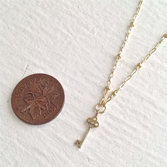 Minerva Tiny Key Charm Necklace in Gold