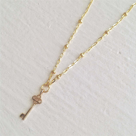Minerva Tiny Key Charm Necklace in Gold